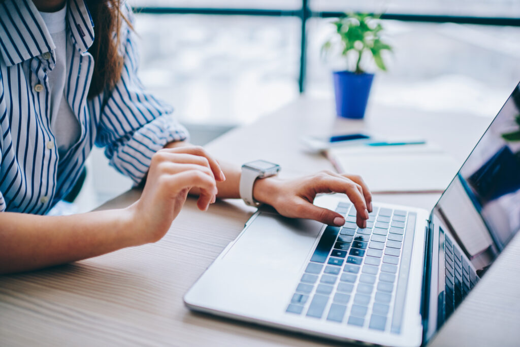 Cropped image of female hands searching web information during s