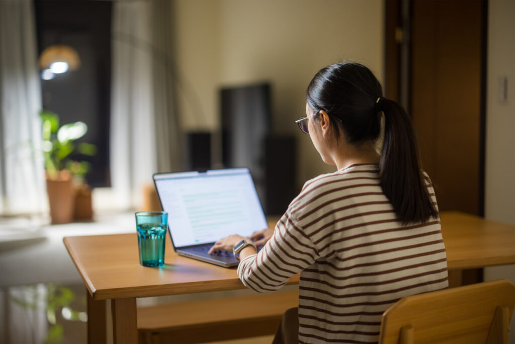 Woman work form home with laptop in the evening